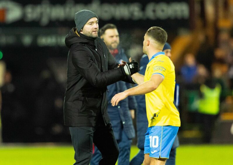 Dunfermline boss James McPake shakes hands with Raith Rovers' striker Lewis Vaughan.