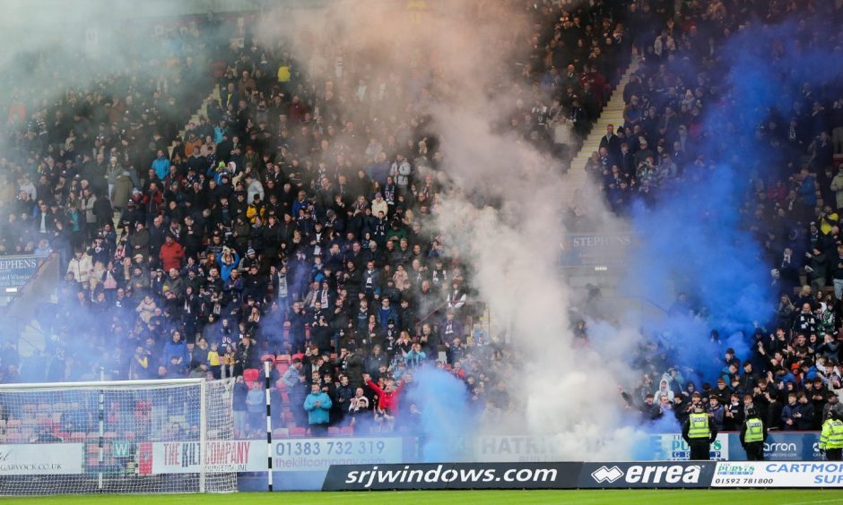 Blue smoke billows around the away end at East End Park housing the Raith Rovers supporters. Image: Ewan Bootman / SNS Group.