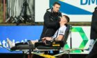 Dunfermline Athletic medical staff treat defender Sam Fisher on a stretcher after he sustained a facial injury in the 2-1 defeat to Raith Rovers. Image: Ewan Bootman / SNS Group.