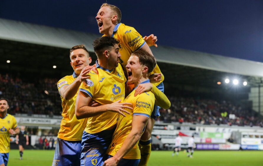 Dan O'Reilly roars with delight and is surrounded by team-mates as they celebrate Raith Rovers' winning goal in the Fife derby victory over Dunfermline Athletic.