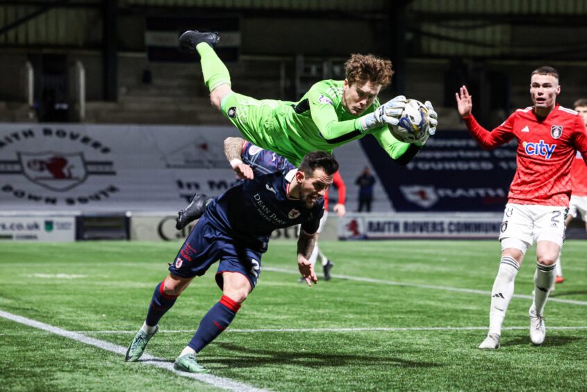 Queen's Park goalkeeper Calum Ferrie jumps over Raith Rovers' Dylan Easton as another chance slips by. Image: Ross MacDonald / SNS Group.