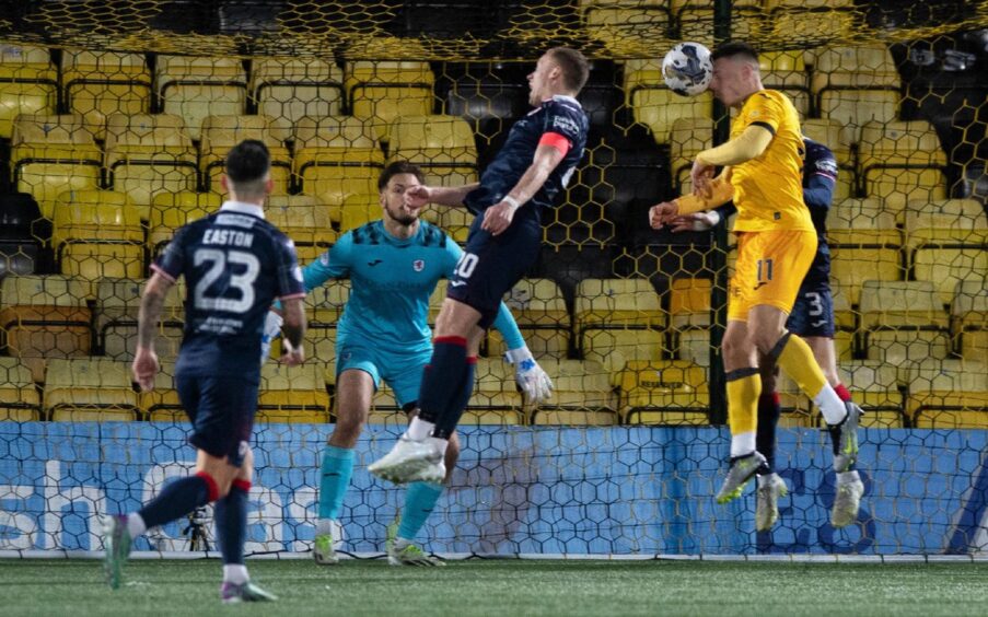 Livingston's Dan MacKay heads in the winning goal, despite the attentions of Scott Brown and Liam Dick. Image: Sammy Turner / SNS Group.
