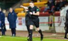 Referee John Beaton points to the spot awarding Aberdeen a VAR penalty.