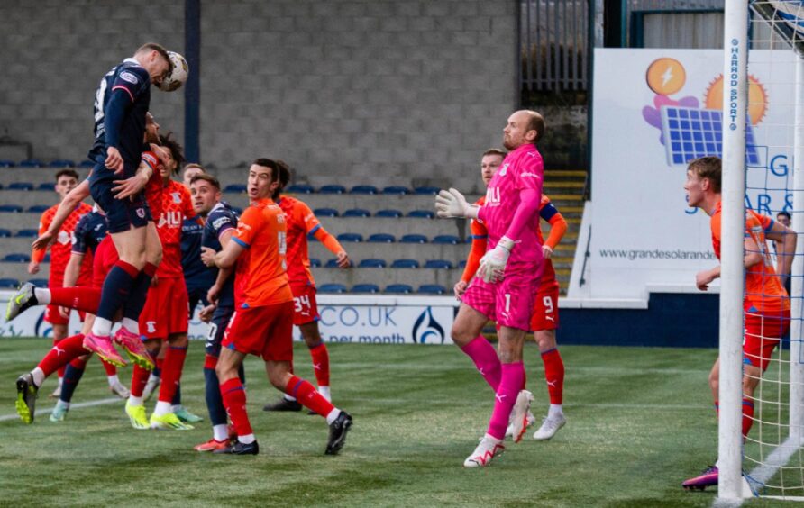 Jack Hamilton leaps highest in a crowded box to head in the opening goal for Raith Rovers.
