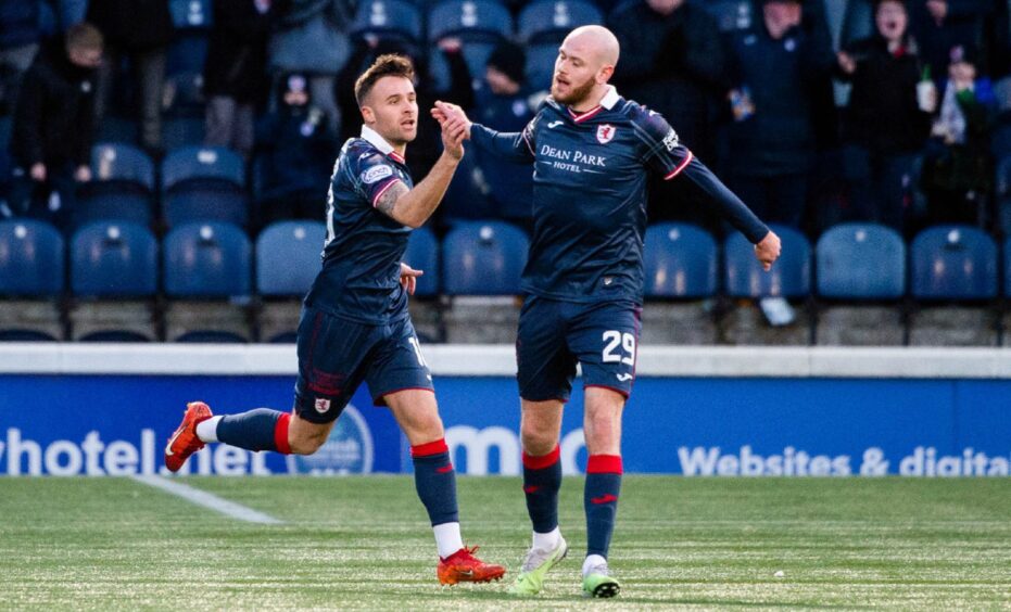 Lewis Vaughan and Zak Rudden shake hands as they celebrate after the former's goal against Inverness Caley Thistle.