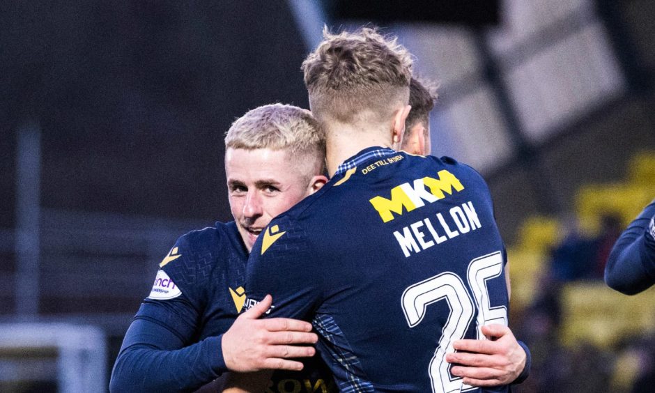 Mellon gets a hug from Luke McCowan after Dundee went 2-0 up. Image: SNS