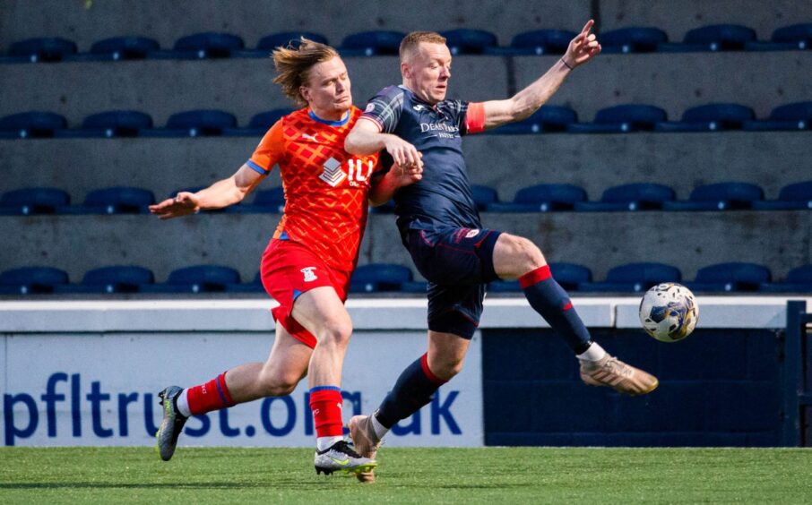 Raith Rovers captain Scott Brown holds off Inverness Caley Thistle striker Alex Samuel to get his foot to the ball first.