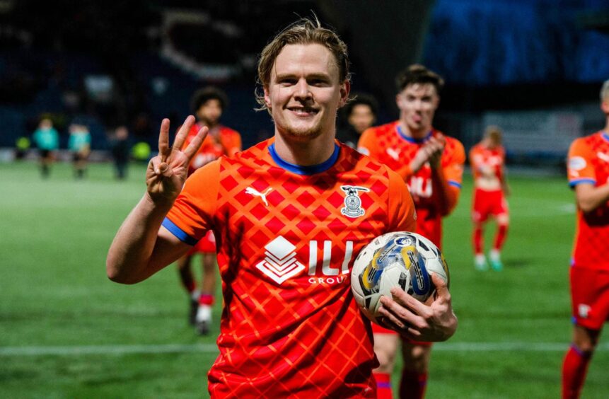 Inverness striker Alex Samuel clutches the match ball and holds up three fingers after his hat-trick against Raith Rovers.