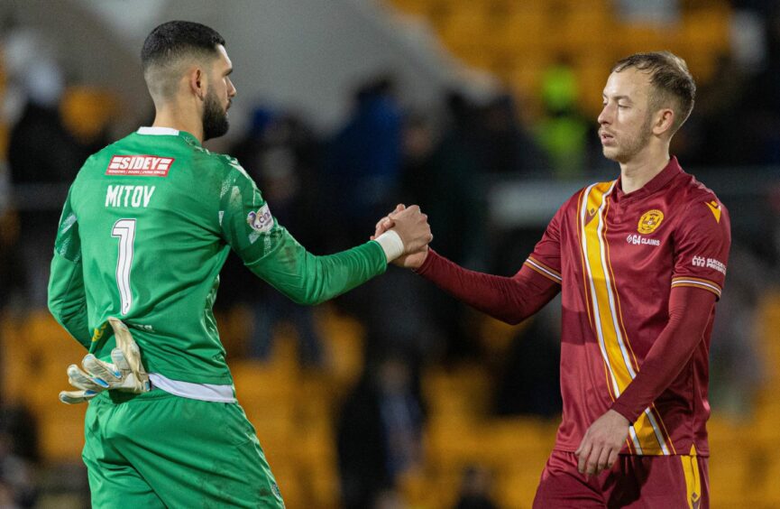 Motherwell's Harry Paton and St Johnstone's Dimitar Mitov shake hands at full-time.