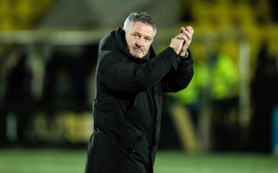 Tony Docherty applauds Dundee fans after winning at Livingston. Image: SNS