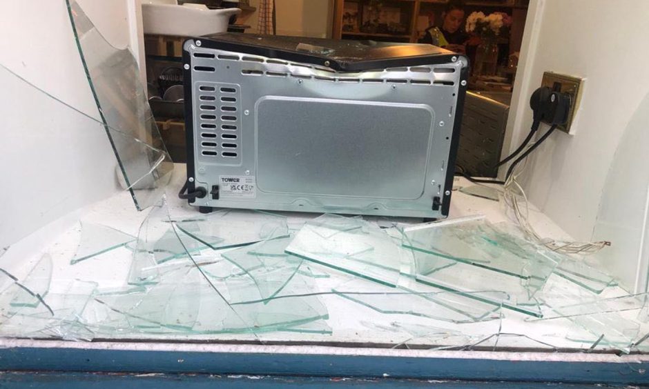 Smashed kitchen window of Johnnie Orange Cafe in Perth.