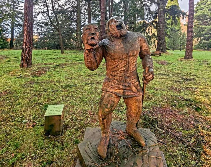 The rather disturbing sculpture of Macduff holding Macbeth's severed head aloft on one of the artworks found on the Macbeth Trail. Image: Gayle Ritchie.