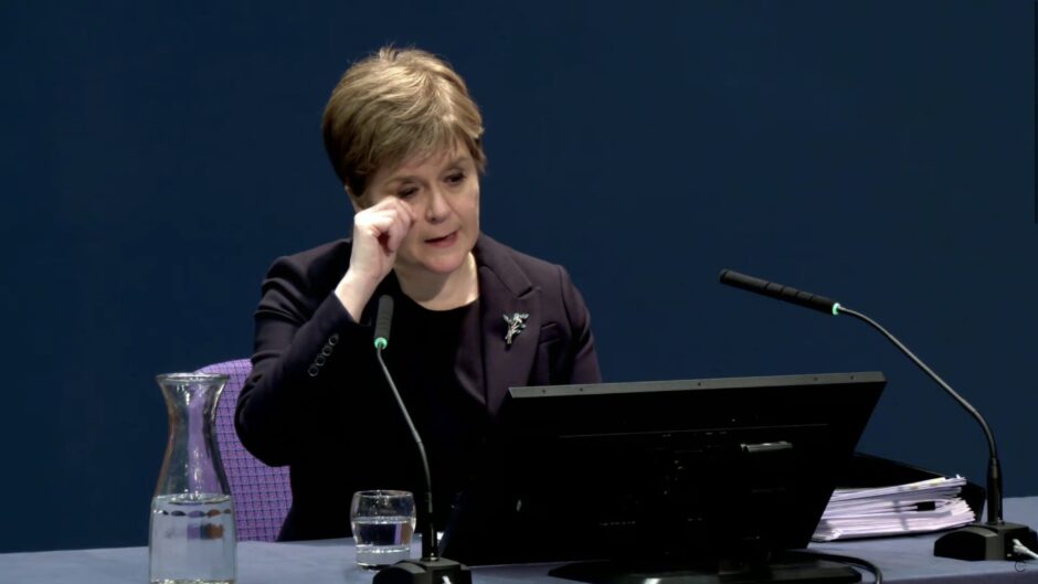 Nicola Sturgeon wiping her eye while seated at a desk as she gives evidence to the Covid inquiry