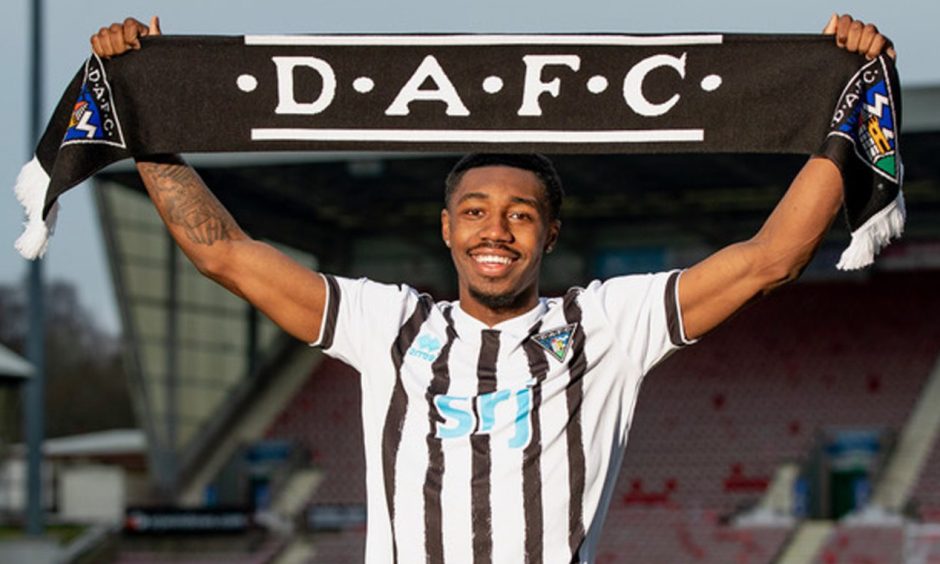 Malachi Fagan-Walcott raises a DAFC scarf above his head at East End Park.