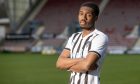 New Dunfermline Athletic loan signing Malachi Fagan-Walcott stands with his arms folded at the club's East End Park stadium. Image: Craig Brown / DAFC.