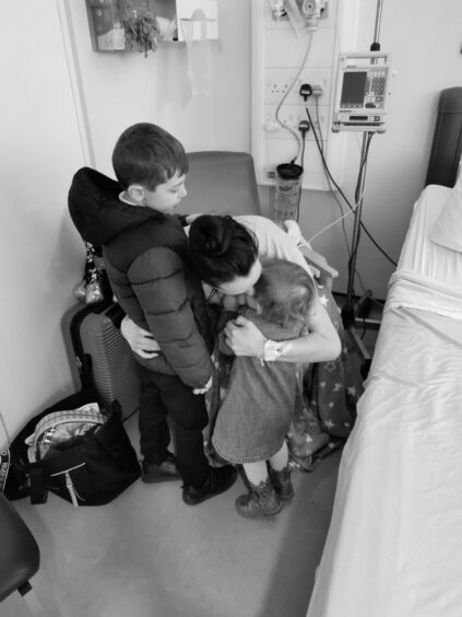 Emma pictured with her two children after her surgery.