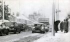 Cars and pedestrians battle through the snow in Dundee. Image: DC Thomson.