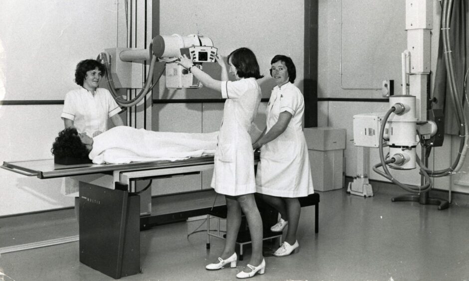 Radiographers Sheila Nisbet, Agnes Lewis, and Frances Anderson at work on the X-ray equipment at DRI A&E in 1976.