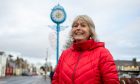 Jean Lee with Monifieth's famous blue clock on the High Street. Image: Kim Cessford / DC Thomson