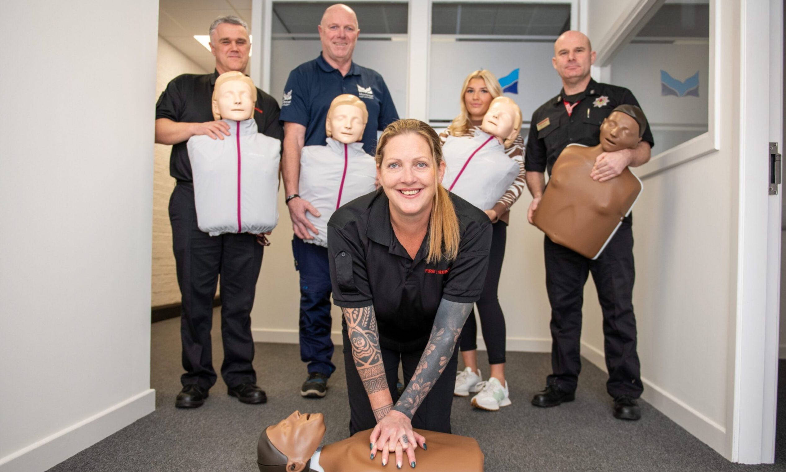 Lisa Cox of SFRS using one of the new mannequins with (back from left) Kenny Petrie, SFRS; Kenny Gammie and Ellie Emslie of Montrose Port Authority and Gary Wood, SFRS.