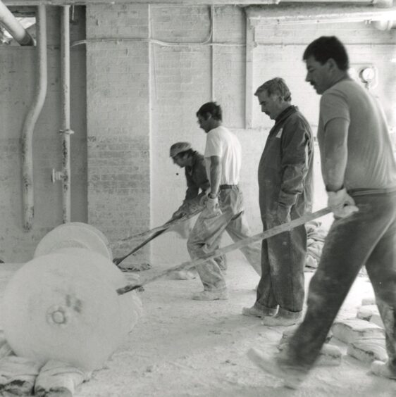 Workers cutting linoleum cement, Forbo Factory, Den Road, Kirkcaldy in 1992.
