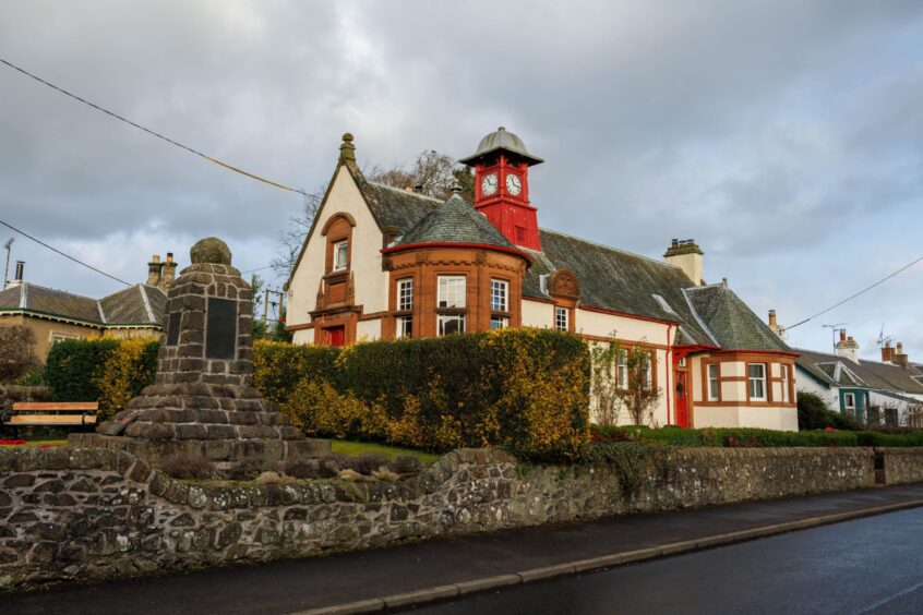 Old Glenfarg library building, now converted into a family home, with war memorial outside.