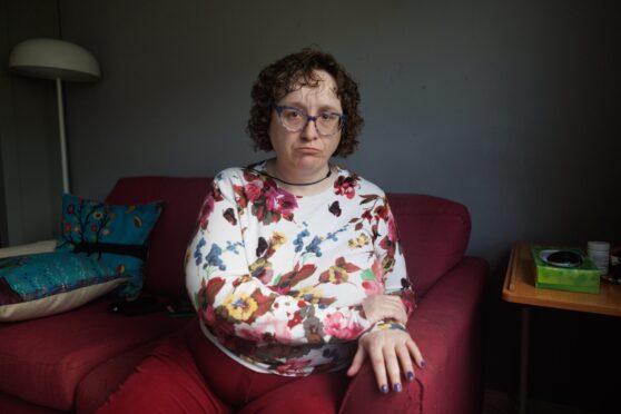 Karen Robertson seated in her home with serious expression