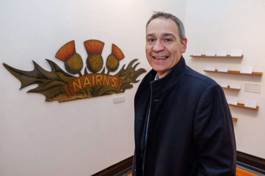 Angus Fotheringham, Forbo UK and Ireland general manager, with the old Nairn's factory sign at the lino exhibition  in the Kirkcaldy Galleries.