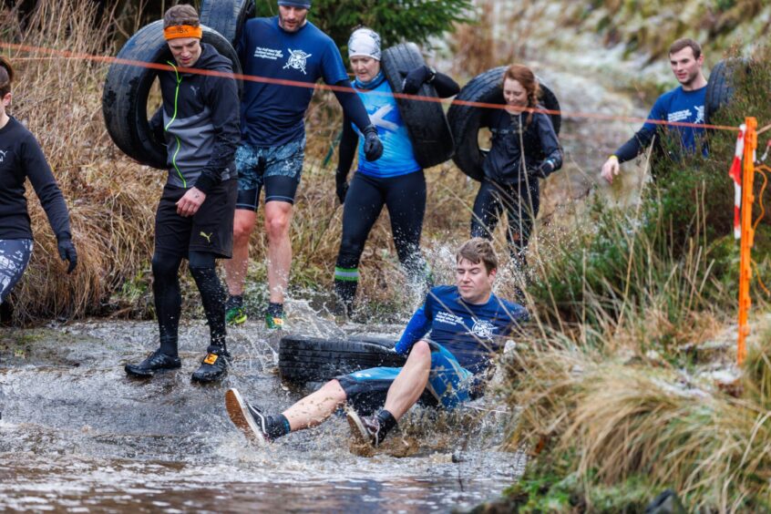 A competitor falls into the icy water as he takes on the challenge.