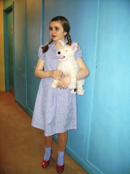 A 12-year-old Lucy getting ready to play Dorothy in her self-directed production of The Wizard of Oz. Image: Playhouse Theatre Company.