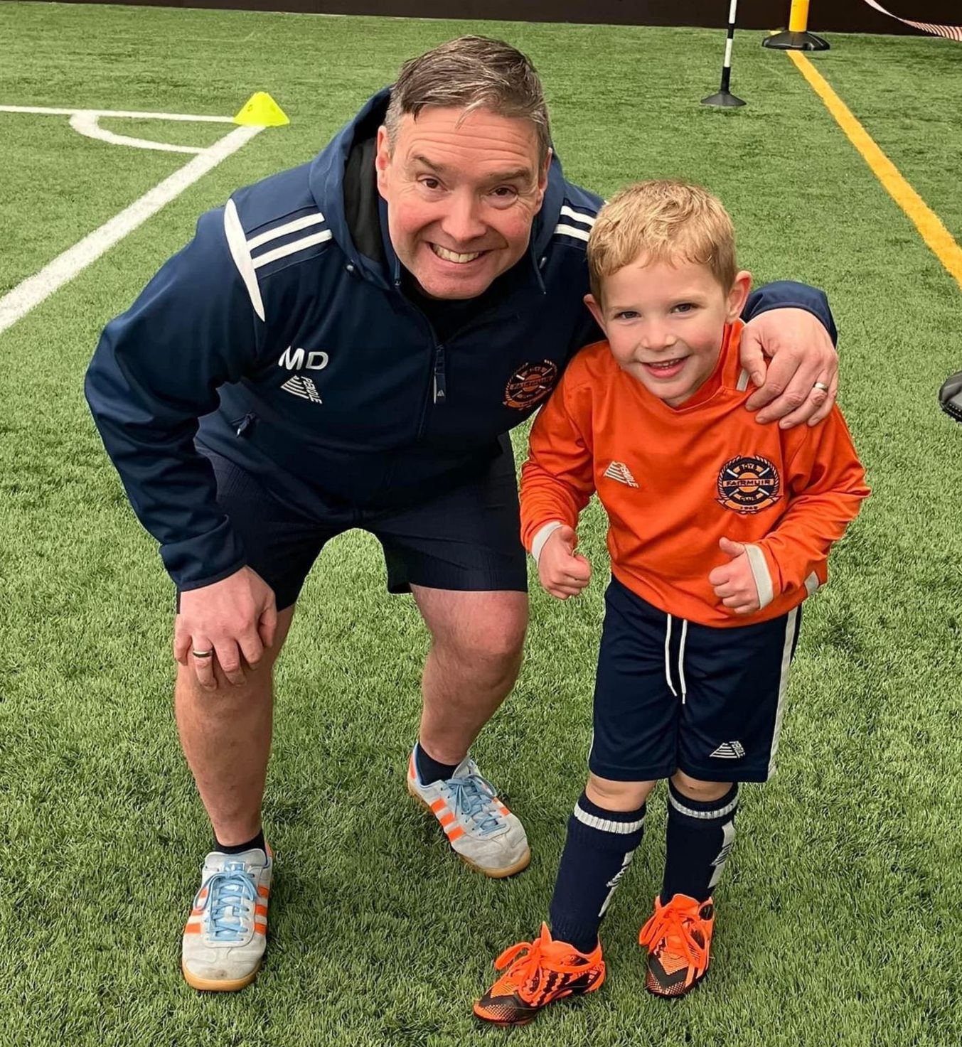 Mike Donnelly with a young footballer.