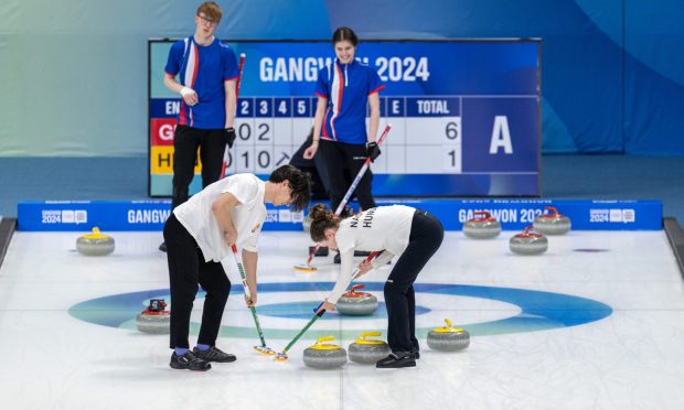 Hungary's pair sweep the ice as Great Britain's Ethan Brewster and Callie Soutar look on in their round robin encounter at Gangwon 2024. Image: Joe Toth for OIS/IOC/PA Wire.