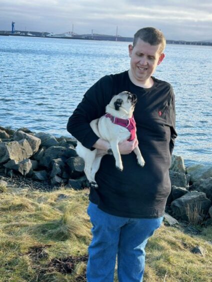  Peter Gray now weighs 21 stone. He is pictured while out walking with pug Daisy. 