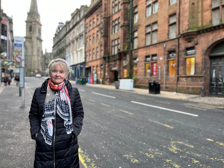 Professor Jill Belch stands on a Dundee City Centre street.