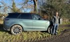 Our motoring writer with the Range Rover Sport in Moffat, with trees and a field behind him