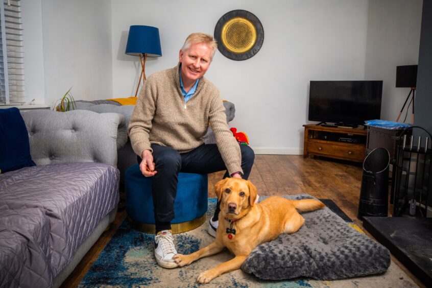 Ian at home in Stirlingshire with dog Molly.