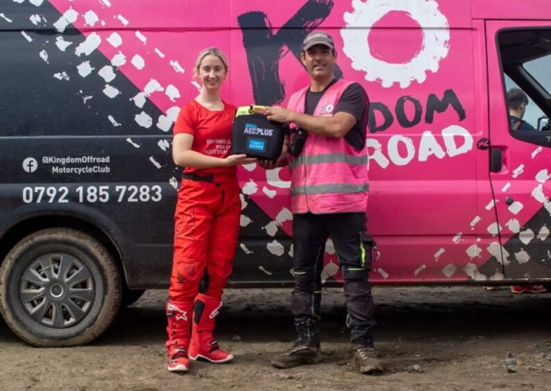 Sara Joiner presents David Paton from Kingdom Off-road Motocorss Club in Fife with the defibrillator. 