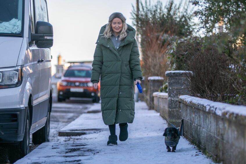 Rachel walking her dog Sheldon.