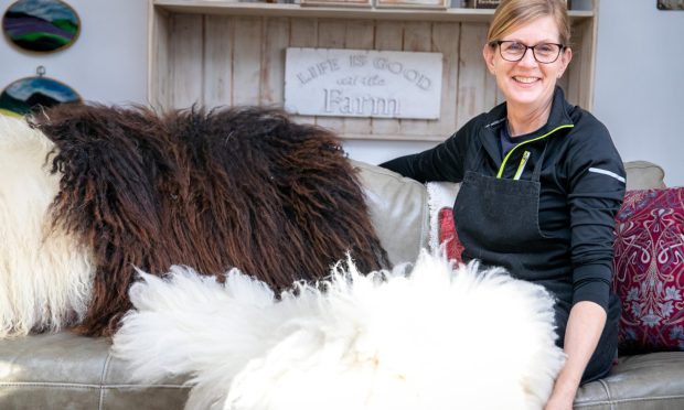 Trich O'Meara with some of her finished sheep fleece rugs