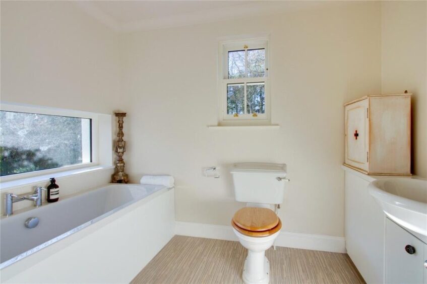 The bathroom which sits of a bedroom. 