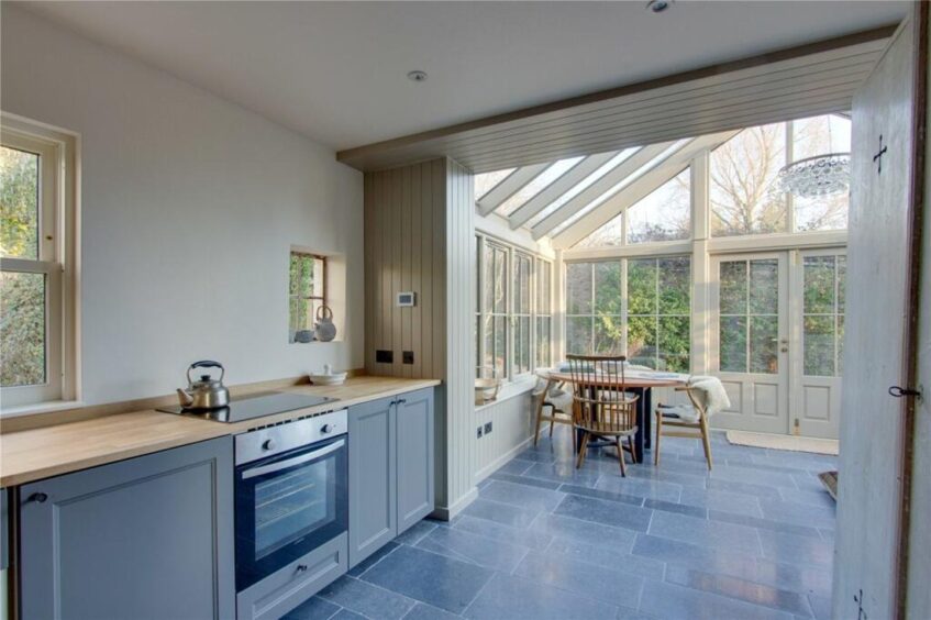 The conservatory leads to the modern kitchen.