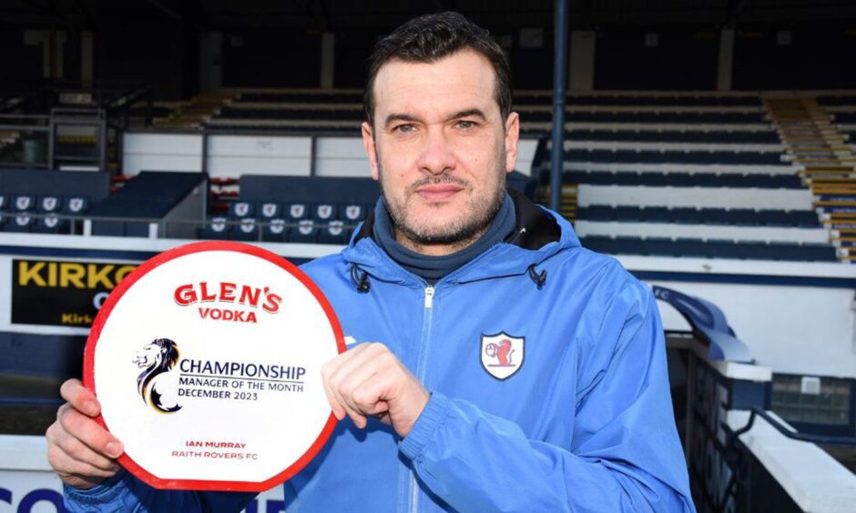 Raith Rovers manager Ian Murray holds up his Championship manager of the month for December award.