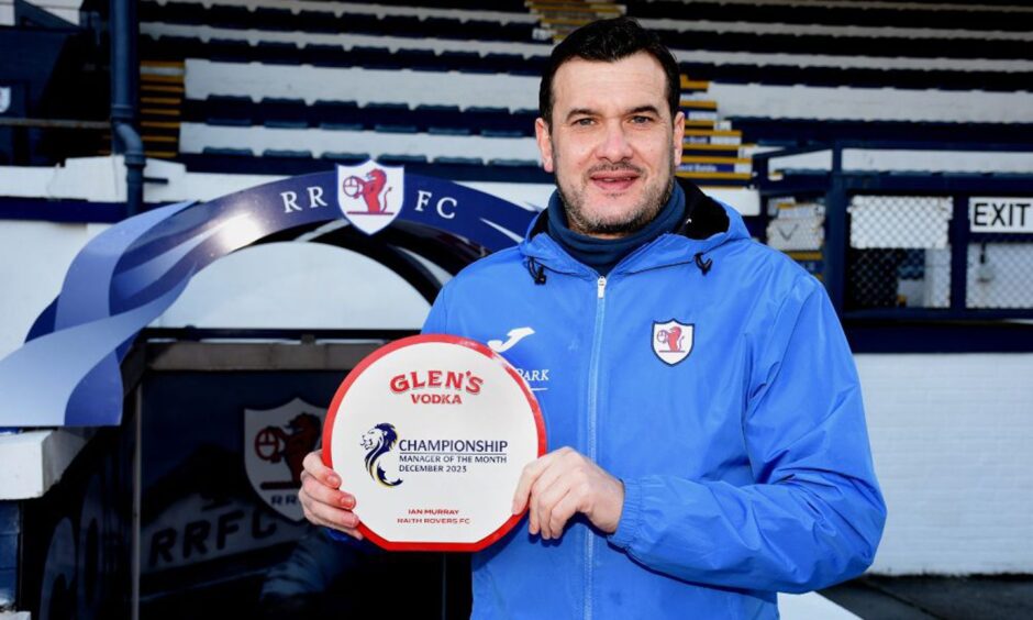 Raith Rovers boss Ian Murray stands with his trophy after being named the Championship manager of the month for December. Image: SPFL.