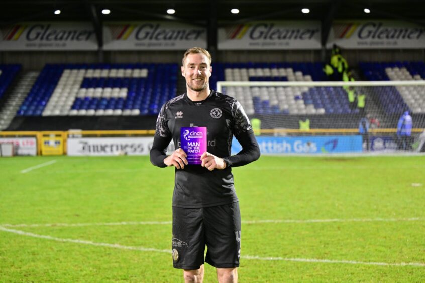 Kevin Holt clutches a man of the match award following Inverness vs Dundee United 