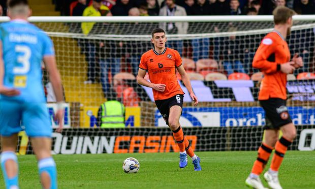 Dundee United's Ross Graham strides out of defence
