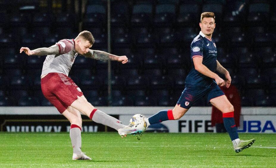 Ali Adams fires in a stunning goal for Arbroath as Raith Rovers defender Euan Murray watches on.