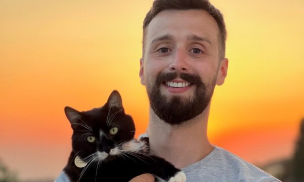 Rob Lindsay and their own pet cat Bella in Cyprus.