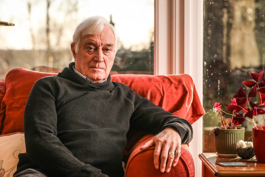 Bill Duncan sits in a red armchair at his home in Liff.