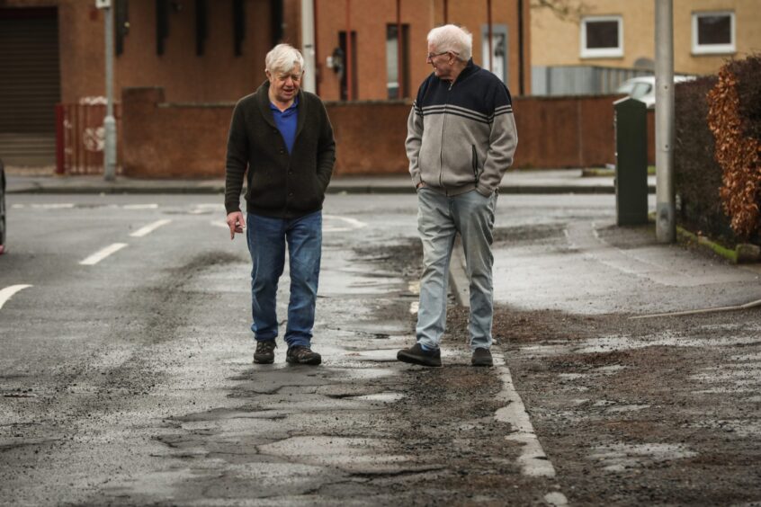 Residents of Finlow Terrace in Dundee by the potholes 