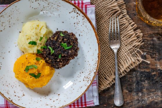 A photo of haggis, neeps and tatties on a plate